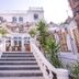 La Palmeraie in La Baule-Escoublac: white hotel facade with grand steps, palm trees and terrace