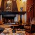 Hotel Casa da Montanha in Gramado lounge with fireplace, ornate decor, and vintage seating