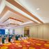 The Longemont Shenyang conference room with banquet-style tables and colorful patterned carpet