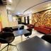 Hotel 99 Cubao in Manila lobby lounge with black tables, red sofas, and ornate wall mural