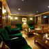 Hilton Frankfurt Gravenbruch lounge in Neu Isenburg with green velvet chairs, leather sofas and warm lighting