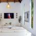 Le Cameleon Boutique Hotel, Puerto Viejo de Talamanca: bright lounge with white sofa and tropical garden view