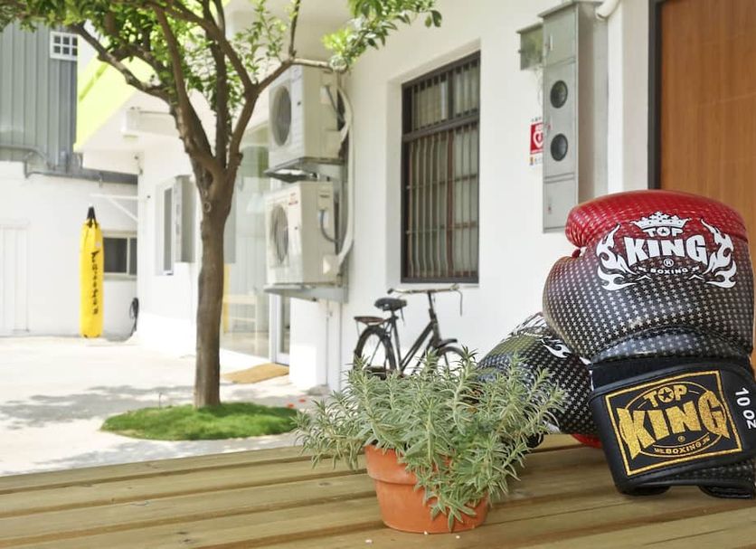 T-Life Hostel in Taichung City entrance with stacked KING-branded beanbags, potted plants, and bicycle