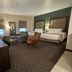 Best Western Plus Chihuahua Juventud room with two beds, seating area and city-view windows in Chihuahua