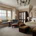 The Gleneagles Hotel Auchterarder bedroom with king bed, window seat, and mountain-view window