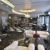 Asdal Boutique Hotel Seef Manama lobby with chandelier, black-and-white tile floor, and seating area