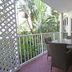 Cairns Beach Resort Holloways Beach balcony with table and chairs overlooking tropical greenery
