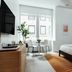 Mint House at 70 Pine, New York hotel room with bed, dining table by window, and city view