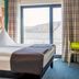 B&B Hotel Aalen guest room with double bed and window view of rooftops and hills