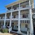 Quaker Inn in Ocean Grove, white-columned historic hotel exterior with balconies and blue sky