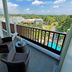 Balcony at Aston Bogor Hotel and Resort in Bogor with lounge chairs and pool and garden view