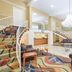 Days Inn Roanoke Near I-81 lobby with staircase, chandelier, seating area, and front desk