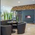 Hotel Stadt Mühlhausen lounge with fireplace seating and stacked wood wall, Mühlhausen