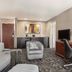 Courtyard by Marriott San Jose South/Morgan Hill guest room with sofa, desk, chair and TV in Morgan Hill