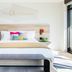 Hotel San Luis Obispo guest room with king bed, bedside lamps, and bright modern windows in San Luis Obispo