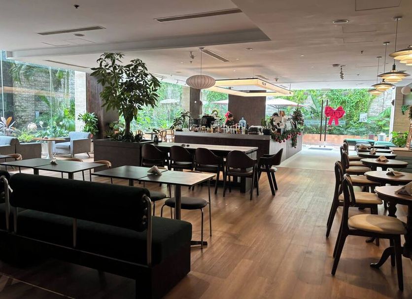 Vissai Saigon Hotel in Ho Chi Minh City restaurant with large windows, wood floors and modern seating