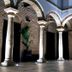 Patios del Orfebre in Córdoba courtyard with stone arches, columns and potted plant