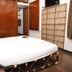 La Villa Creole Pondicherry guest room with bed, wooden wardrobe and bamboo room divider