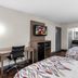 Red Roof Inn Richmond - Airport Sandston room with two beds, desk, TV, and bathroom doorway