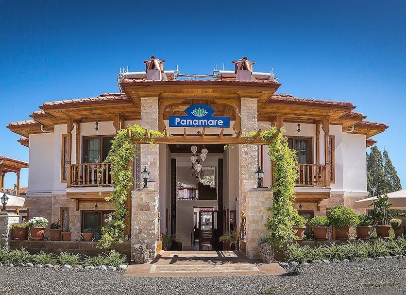 Panamare Apart Hotel Akyaka exterior entrance in Akyaka with wooden balconies and stone facade