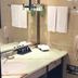 Ramada Plaza by Wyndham Tian Lu Hotel Wuhan bathroom with vanity, towels, and wall-mounted phone
