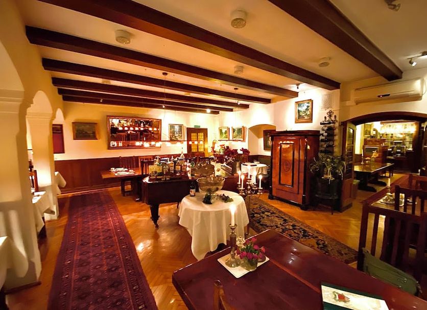 Waldhotel Silbermühle in Horn-Bad Meinberg dining room with bar, wood beams and set tables