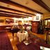 Waldhotel Silbermühle in Horn-Bad Meinberg dining room with bar, wood beams and set tables