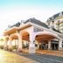Disney's Riviera Resort in Lake Buena Vista with grand porte cochere and palm-lined hotel exterior