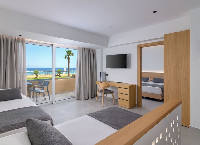 Sun Beach Resort in Ialysos guest room with balcony sea view, palm trees, desks and twin beds