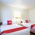 Budgetlodge in Oklahoma City guest room with two double beds, white bedding and red runners