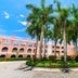 Mizner Place at Weston Town Center in Weston with palm trees and pink courtyard buildings
