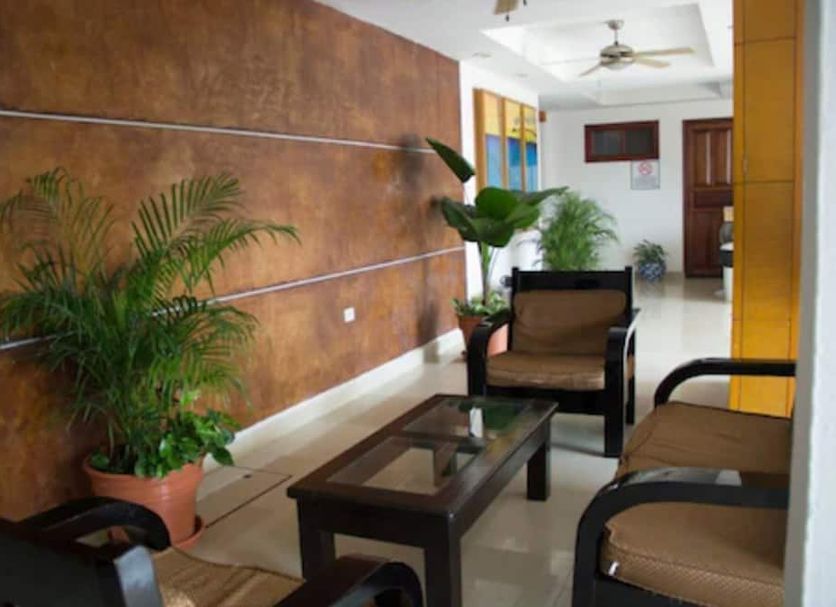 Hotel Madan Cardenas lobby seating area with potted plants and glass coffee table in Cárdenas