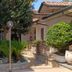 Hotel La Fayette Licola in Giugliano in Campania courtyard with palm trees, potted shrubs and walkway