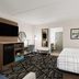 La Quinta Inn & Suites by Wyndham Atlanta Roswell guest room with bed, desk, TV and mini fridge