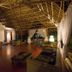 Konokono Beach Resort and Isaraya Over Water Villa in Michamvi: open-air lounge with thatched roof and curtains