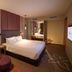 Mercure Selangor Selayang room in Batu Caves with a king bed, lounge chair and floor lamp