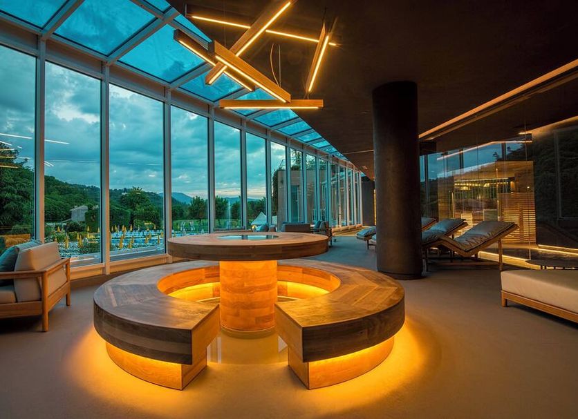Terme Preistoriche Resort & Spa in Montegrotto Terme spa lounge with glowing circular seating and poolside views