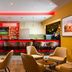 Leonardo Hotel Offenbach Frankfurt bar lounge in Offenbach am Main with red-lit bar and seating area