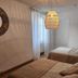 Le Clos Loret in Saint-Germain-du-Corbéis bedroom with two beds, woven pendant light and round mirror
