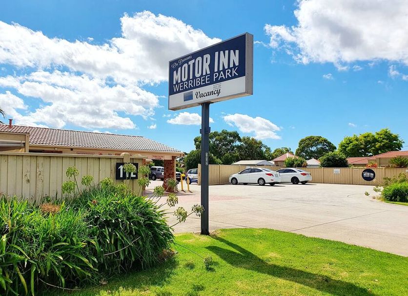 Werribee Park Motor Inn in Werribee exterior with sign, parking lot, and landscaped grounds