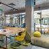 ibis budget Tbilisi Center lobby lounge with yellow chairs, tables and colorful seating in Tbilisi