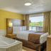 Motel 6 Campbellford On room with jetted tub, bed by window, and view of greenery in Campbellford
