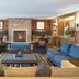 Residences at The Little Nell in Aspen: cozy lounge with fireplace, patterned rug and blue sofa