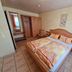 Zur Rotenfelsstube in Norheim: a guest room with double bed, wardrobe, tiled floor and window light