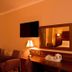 Dillons Hotel in Letterkenny guest room with wall-mounted TV, lamp, mirror, and tea tray
