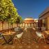 Sterling Amargarh Jodhpur rooftop terrace with outdoor dining tables and a lit pavilion in Jodhpur