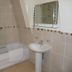 The Woodvale, Cowes: tiled bathroom with bathtub, shower, pedestal sink and wall mirror