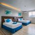 Brisa Marina Beach Resort powered by Cocotel in Morong: bright twin-bed guest room with window and wall-mounted TV