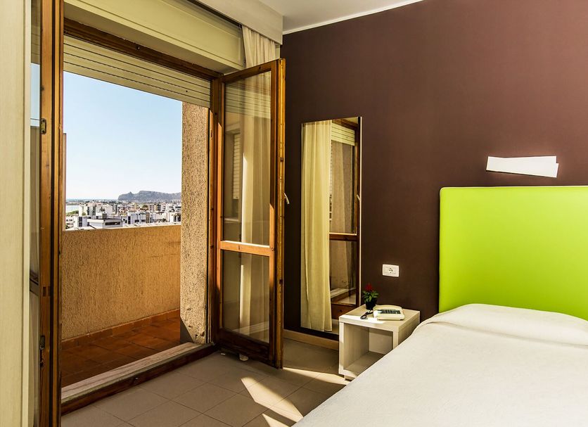 Hotel Residence Ulivi e Palme Cagliari room with balcony door and city view