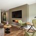 Sporthotel Grafenwald in Daun living area with sofa, TV, fireplace and seating nook
